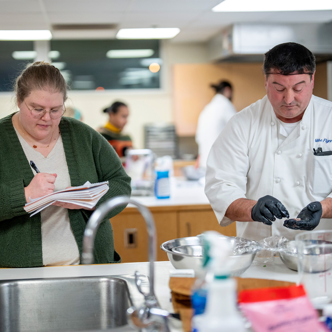 Students and chefs conducting research on food waste prevention of squid fins.