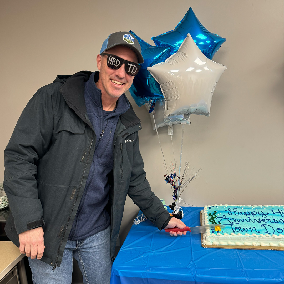 Ryan Clark, President & CEO of The Town Dock, cutting the 44th anniversary cake.