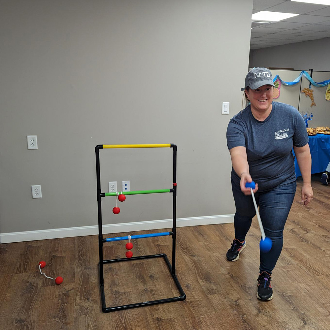 TD employee playing a game of ladder toss.